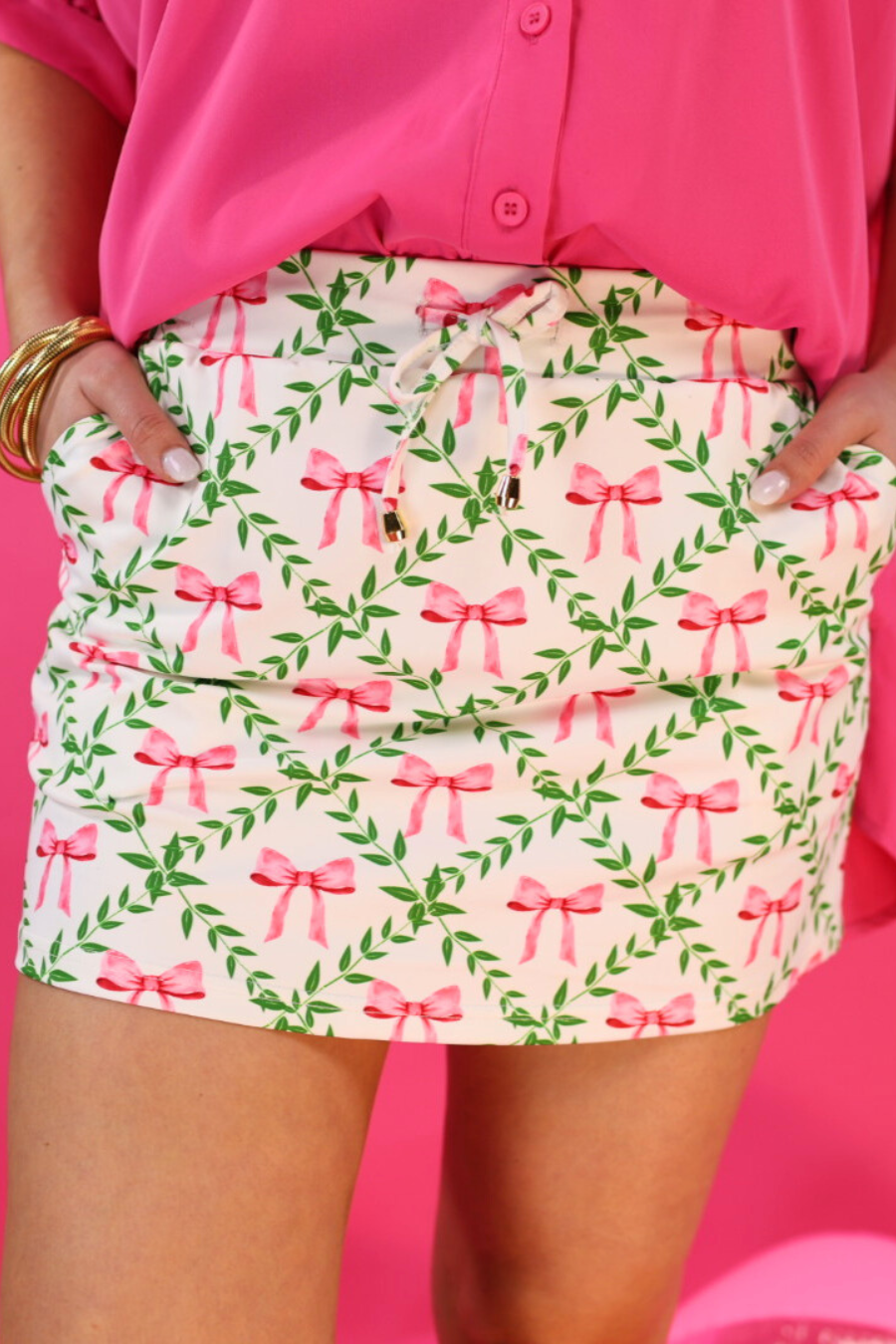 white skort with green vine detail and pink bows