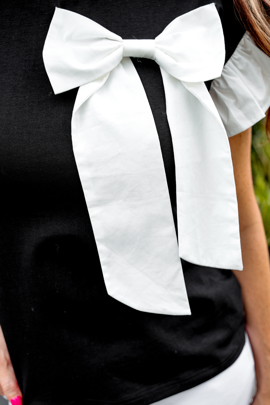 Womens black top with large white bow